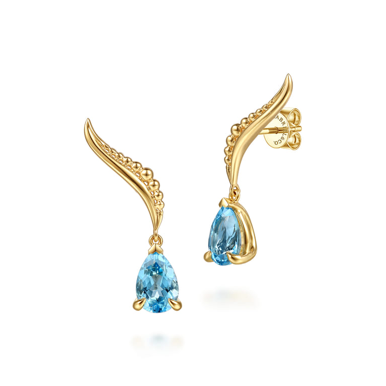 14K Yellow Gold Graduating Bujukan Pear Blue Topaz Stud Earrings - Shot 1