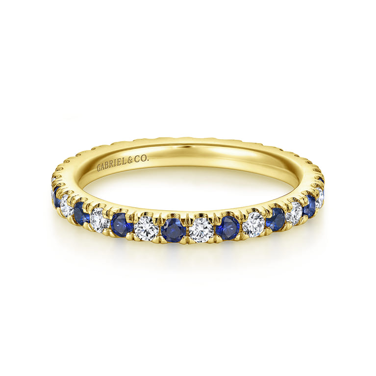 Eternity Band Wedding Ring in 14k Yellow Gold with Round Sapphire at Gabriel & Co. - Shot 1