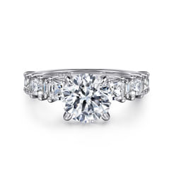 This magnificent 1.13ct diamond engagement ring has a sophisticated way with shapes. Baguette and princess cut diamonds alternate across the top half of a reverse tapered shank that supports your choice of 2ct round center stone. Like your love, this 18K white gold ring will last a lifetime.