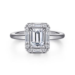 An Art Deco inspired halo plays up the vintage appeal of your 1.25ct emerald cut center stone. The halo features 0.34cts of round and baguette diamonds for intensified sparkle. A simple band of polished 14K white gold completes this radiant ring.