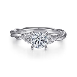 Each braid in this intricately detailed engagement ring is skillfully handcrafted with a modern touch while stunning side stones gently embrace your center stone.