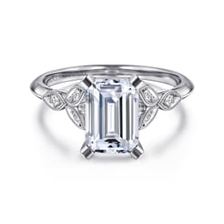 The dainty leaf motif split shank on this 14K white gold emerald cut engagement ring setting adds just enough romantic flair without being overwhelming. Millgrain detailing along the edge adds lovely vintage inspired charm.