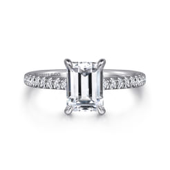 This 14K white gold engagement ring features a streamlined shape with plenty of enchanting sparkle. Your 1.5ct center stone is enhanced by 0.28cts of resplendent accent stones along the upper half of the band and tucked onto the head beneath the center stone. Convey timeless elegance with this straight emerald cut engagement ring.