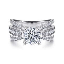 Express your love with 1.08cts of diamonds when you select this contemporary split shank engagement ring. A central row of channel set diamonds and two outer rows of pavé stones flare out from your round cut center stone. Peek-a-boo accents line the basket beneath this 14K white gold cathedral setting.