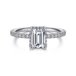 Show her the significance of love with this glamorous hidden halo engagement ring. Carefully encrusted 0.26ct diamonds across the hidden halo and delicately tapered band create an air of sophistication. This 14K white gold setting will showcase your 1ct emerald cut center stone to its best advantage.