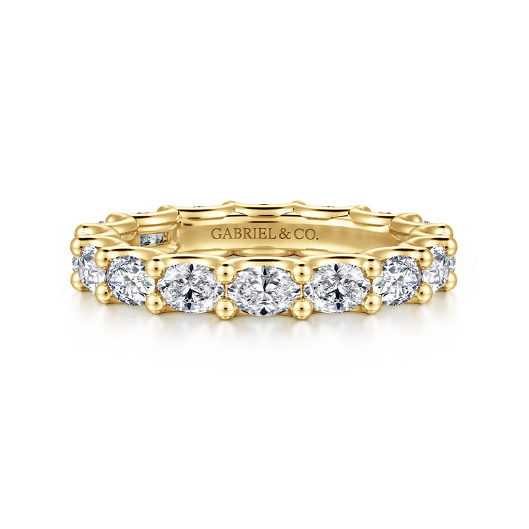 Eternity Band Wedding Ring in 14k Yellow Gold with Oval Natural Diamond at Gabriel & Co. - Shot 1