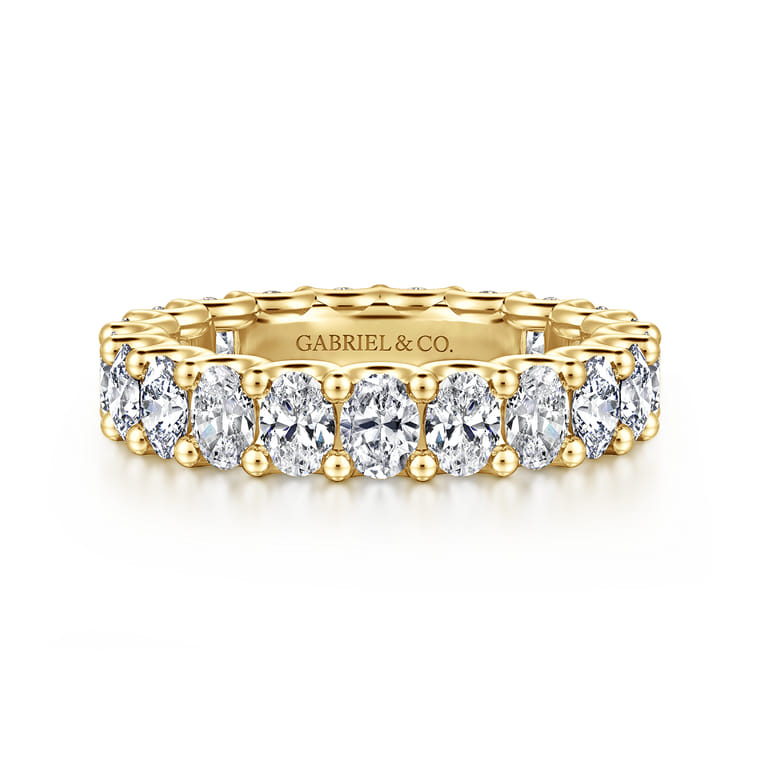 Eternity Band Wedding Ring in 14k Yellow Gold with Oval Natural Diamond at Gabriel & Co. - Shot 1