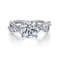This captivating engagement ring features a divided band with 14K white gold ribbons that twist around one another to create a uniquely beautiful design. The shank and gallery beneath the 2ct round cut center stone showcase 0.38cts of radiant pavé diamonds that will dazzle and delight the one you love.