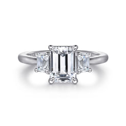 Three cheers for the timeless elegance of this emerald cut 3 stone engagement ring. Two perfectly matched emerald cut side stones collectively add 0.48cts of radiance to a 1.5ct center gem. All three stones are prong set atop a straight shank of polished 14K white gold.